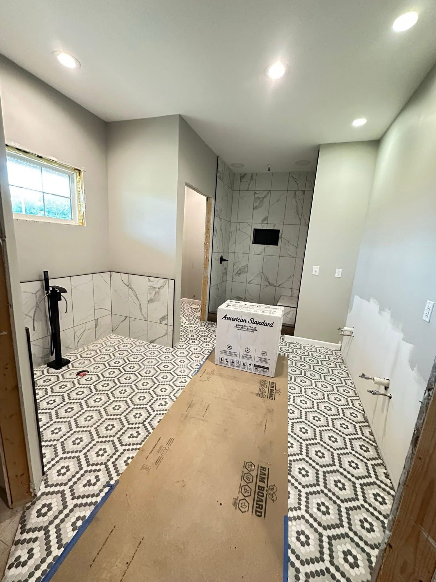 Bathroom after tile shower and mosaic floor